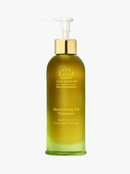 Tata Harper Nourishing Makeup Removing Oil Cleanser green bottle with gold and white top on light grey background